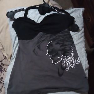 Sleeveless tie around  neck has a skull and it rre